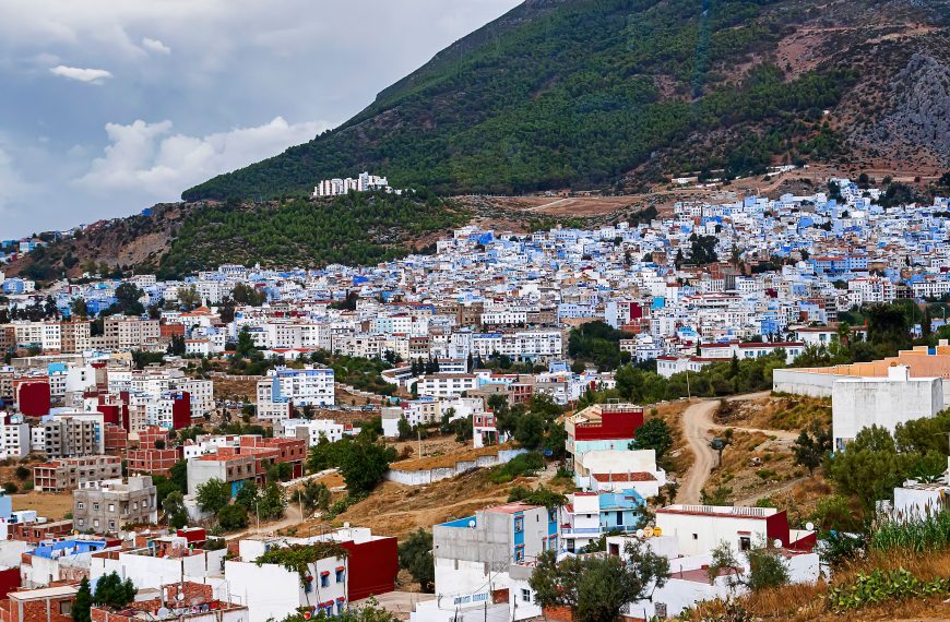 A vibrant panorama of Chefchaouen with its iconic blue buildings nestled in the mountains.